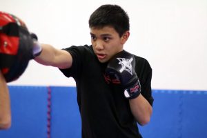 Teenage boy doing non-contact boxing exercise