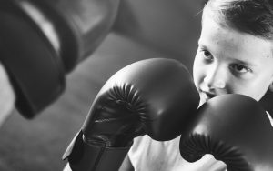 Child wearing boxing gloves